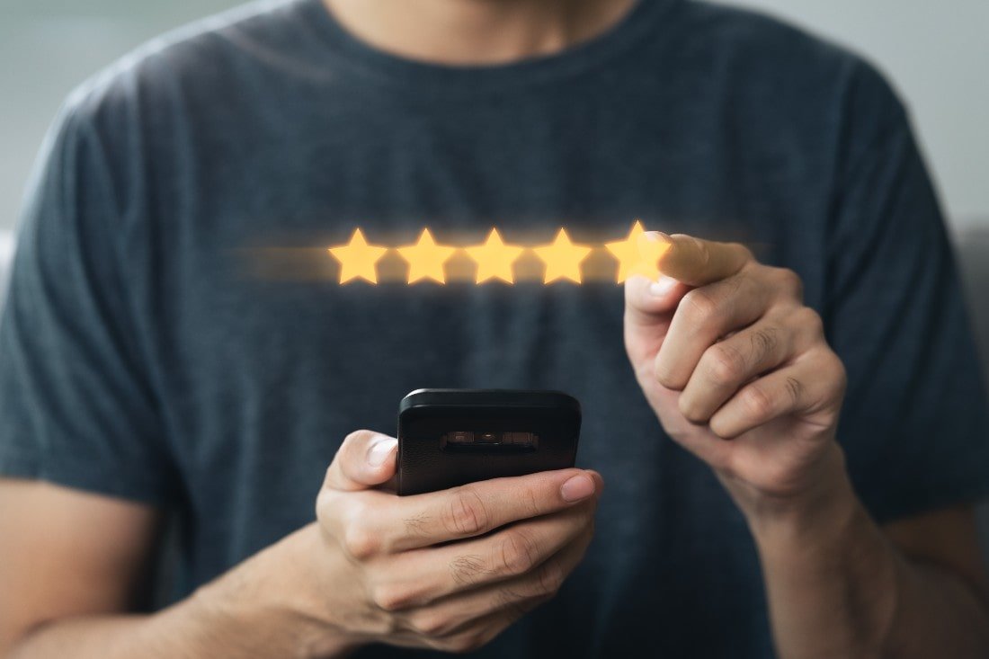 Man giving a five-star rating on an app for a Smartphone