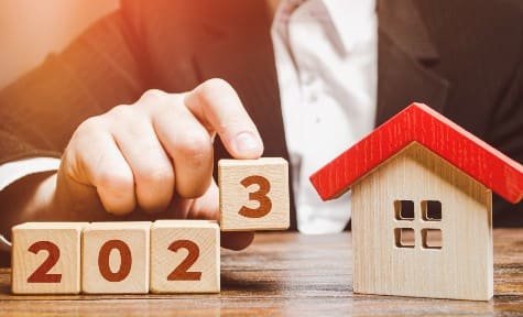 Wooden blocks and a wooden house representing the 2023 real estate market