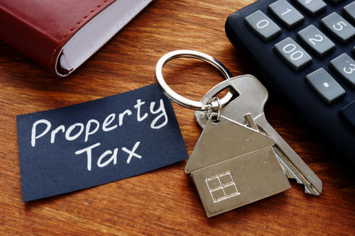 House keys by a sign that says property tax